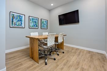 a conference room with a table and chairs and a flat screen tv on the wallat Ironwood Flats, Brandon, FL, 33511